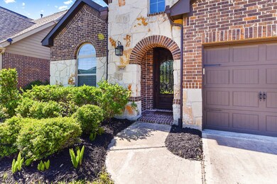 The front door is a beautiful mahogany wood with iron detailing.