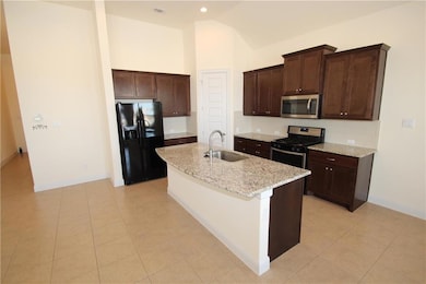 Kitchen with stainless steel appliances, a sink, 
