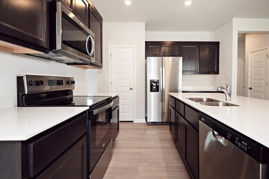 Kitchen with stainless steel appliances, a sink, 
