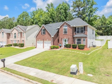 View of front of home featuring brick siding, concrete driveway, an attached garage, and roof with shingles