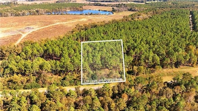 Aerial overview of property's location featuring a large body of water and property boundaries highlighted