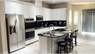 Kitchen featuring stainless steel appliances, a si