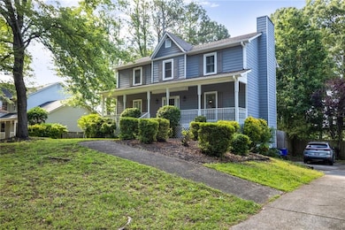 View of front of house with covered porch and a ch
