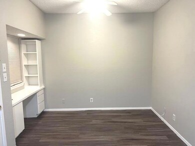 Unfurnished office featuring a ceiling fan, dark 