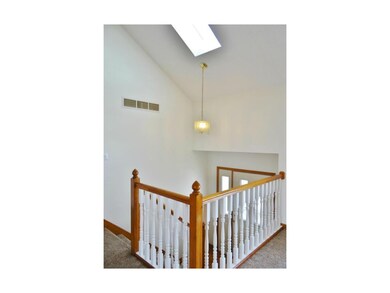 The spacious entryway provides a chandelier, skyli