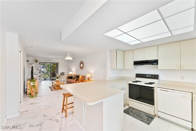 Kitchen with kitchen peninsula, a kitchen bar, whi