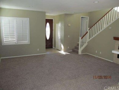 View of living room and entry from dining area