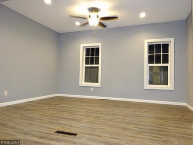 Living room boasts vinyl plank, darker in real lif