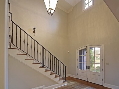 This grand two-story entry sets the stage for an e