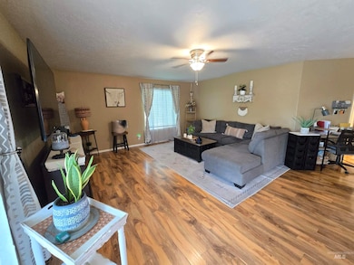 Living room featuring ceiling fan and wood finished floors