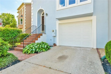 Doorway to property featuring a garage, stucco sid