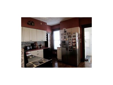 Refrigerator to the right, and back staircase and 