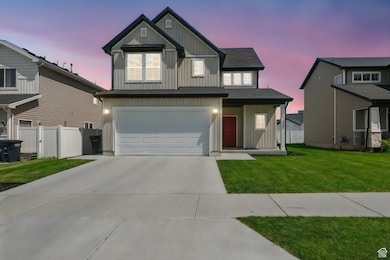View of front facade featuring board and batten siding, an attached garage, and concrete driveway