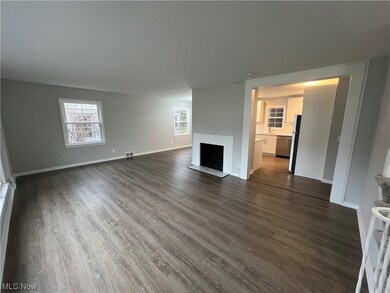 Unfurnished living room with dark wood-type flooring