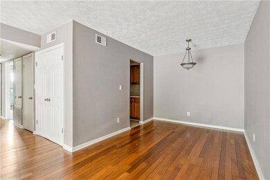 Empty room with wood-type flooring and a textured ceiling
