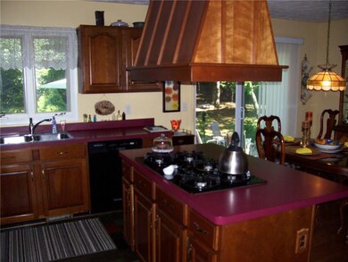 Island has breakfast bar facing dining room.