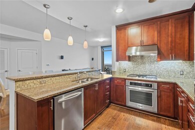 Kitchen featuring kitchen peninsula, hanging light