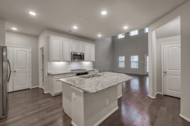 Modern kitchen with white cabinets, stainless stee