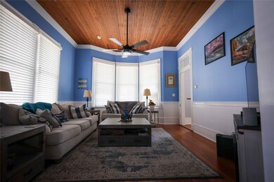 The ceiling is made of rich, wooden planks that ad
