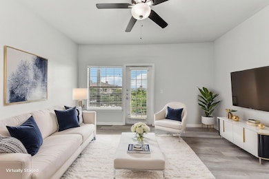 Living room with baseboards, light wood-style flo