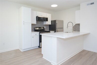 Kitchen with stainless steel appliances, backsplas