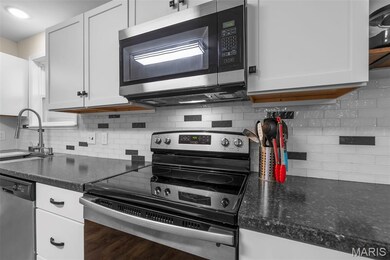 Love to cook? This modern kitchen has stainless appliances, subway backsplash, and tons of counter space!