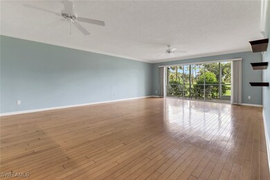 Spare room with ceiling fan, crown molding, hardwo