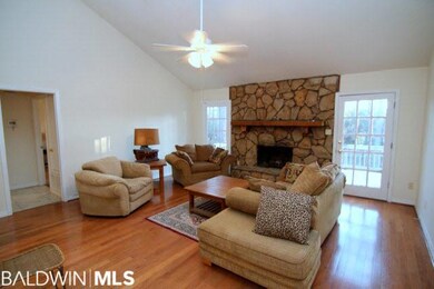 Spacious room with wood floors and fireplace. 16x1