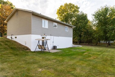Back of property featuring a patio area and a lawn