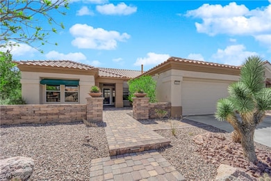 View of front of house featuring concrete driveway