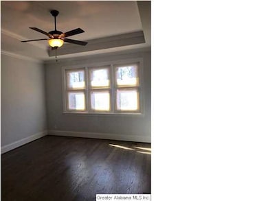 Master bedroom w tray ceiling and hardwood floors