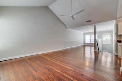 Empty room with high vaulted ceiling, ceiling fan 