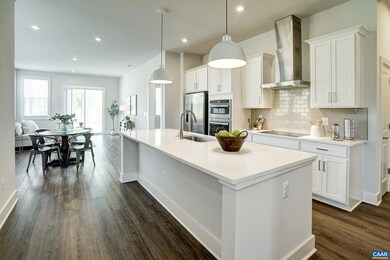 Gourmet kitchen features white cabinets and quartz