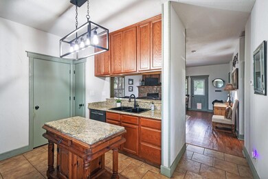Kitchen with dishwasher, a notable chandelier, han