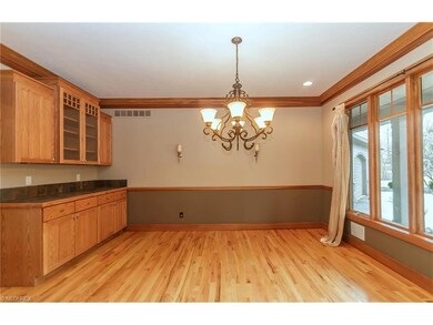 Dining room boasts built-in oak cabinetry, glass c