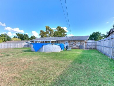 View of yard featuring cooling unit and a covered 