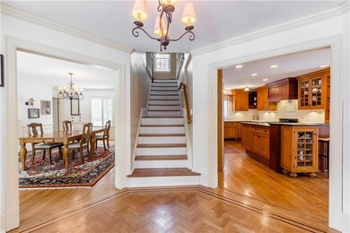 Foyer open to dining room, living room, and eat-in