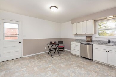 Another view of this Large and NEW Eat-in Kitchen, which also includes NEW Vinyl Flooring, Freshly Painted Interior and walk out.