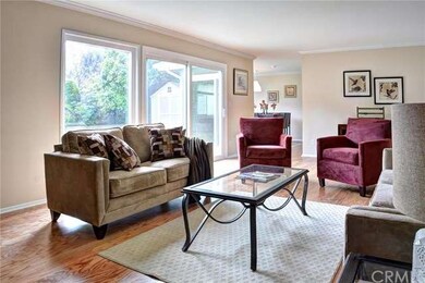 Light filled living room with hardwood floors, cro