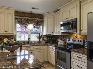 Kitchen. Completely renovated kitchen with glazed cabinetry, tile backsplash, updated appliances, updated fixtures, beautiful granite and tile floors.  It is so pretty...you won t believe your eyes!
