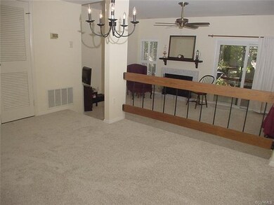 Dining room has open picket railing to living room