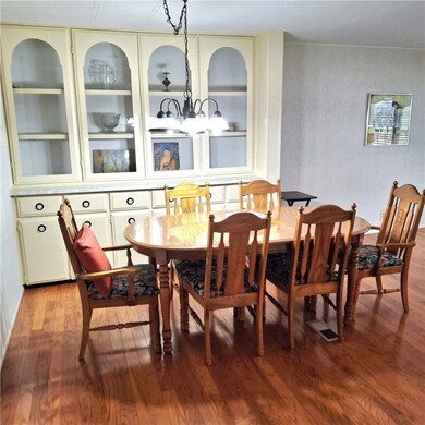 Dining room featuring hardwood / wood-style flooring and built in shelves