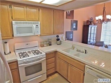 Kitchen with breakfast bar opens to dining area.