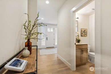 Wide open and light entry way with 3/4 bath on main floor.  Photos are for illustration purposes only and are of the model home, the Magnolia floor plan at Paisley Court on lot 15. Colors, finishes and interior features will vary.