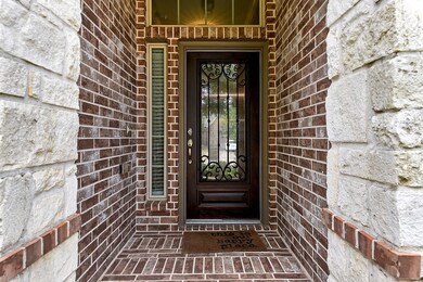 A welcoming entrance with all brick exterior covered porch.