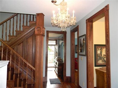 Elegant entry way with red oak woodwork and banist