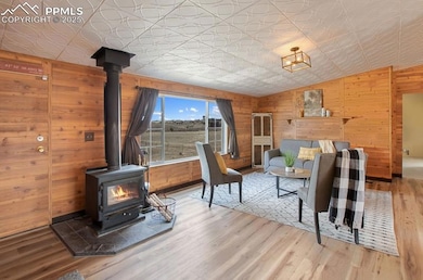 Living room with wood finished floors, wooden wall