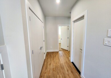 This photo shows a bright hallway with wood-style