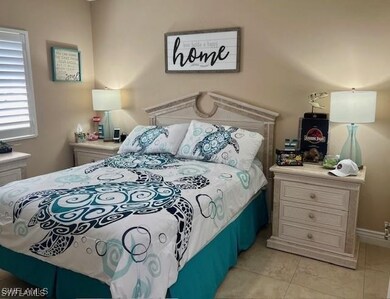 Bedroom with light tile patterned flooring