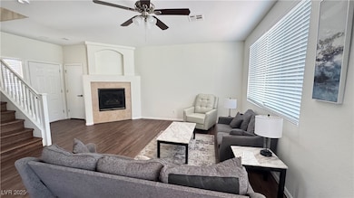Living area with ceiling fan, plenty of natural li
